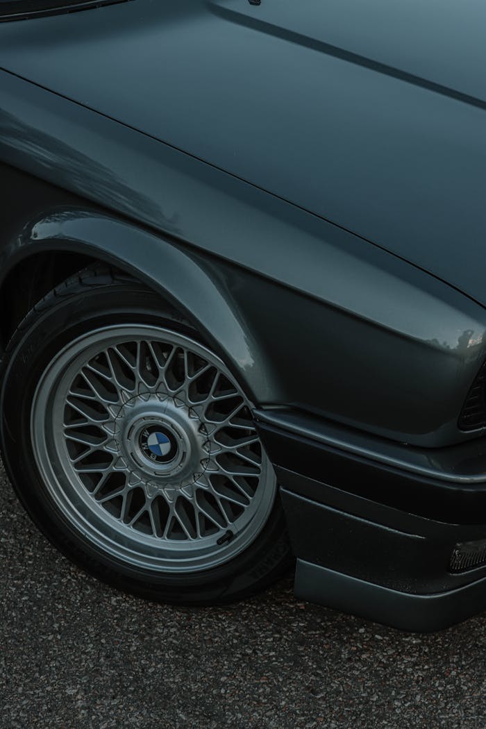 services-01 Detailed close-up of a BMW E30 wheel, showcasing the design and texture.