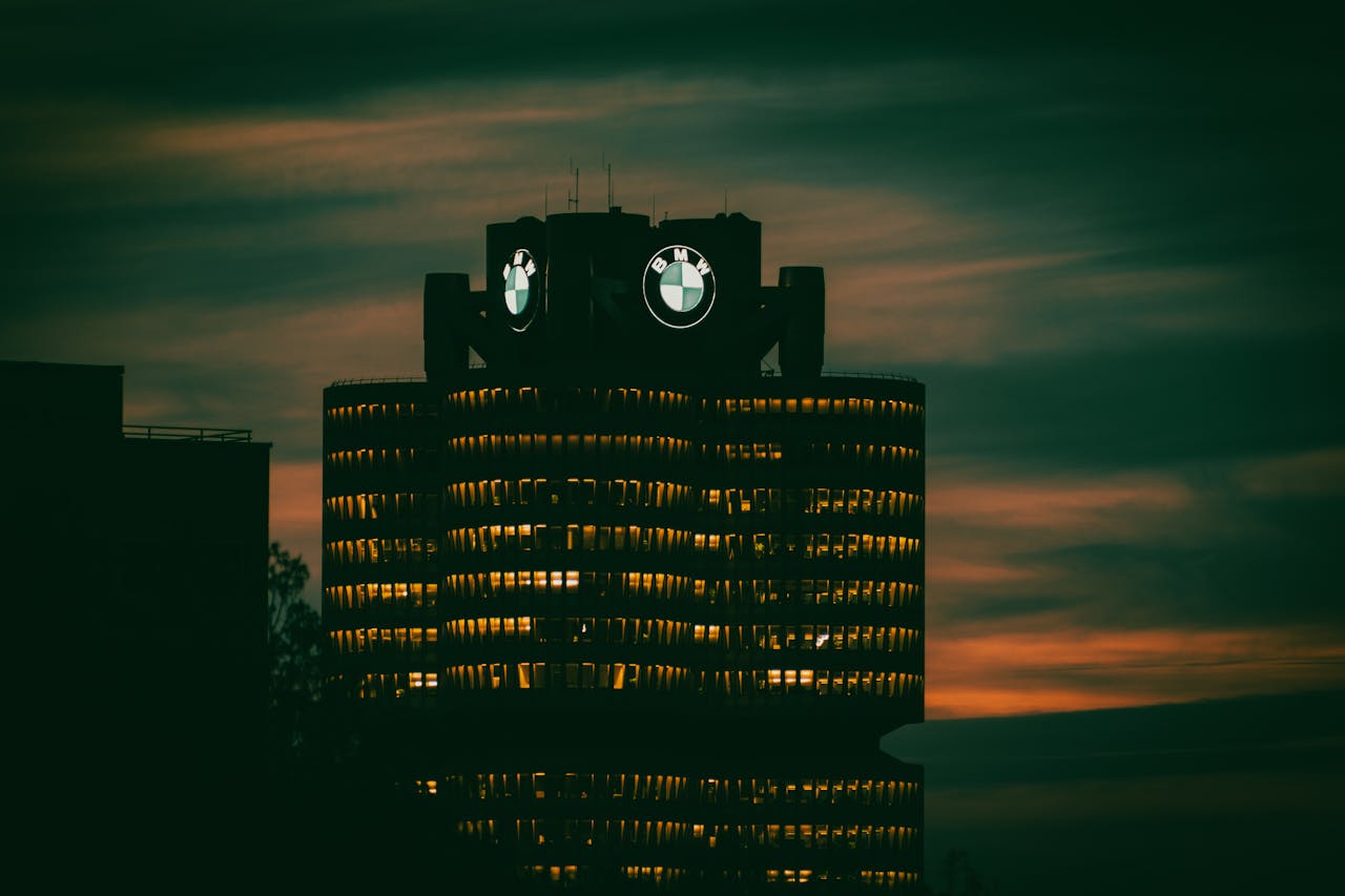 hero-img-02 Dramatic view of BMW headquarters illuminated against the night sky in Munich, Germany.